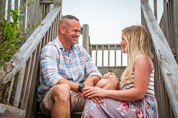 Cute couple celebrating their engagement while vacationing in Corolla, North Carolina in the Outer Banks