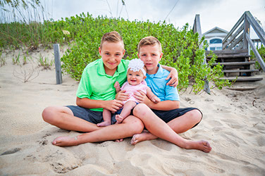 adorable bunch of kids getting their portraits taken while on vacation in Corolla, North Carolina in the Outer Banks